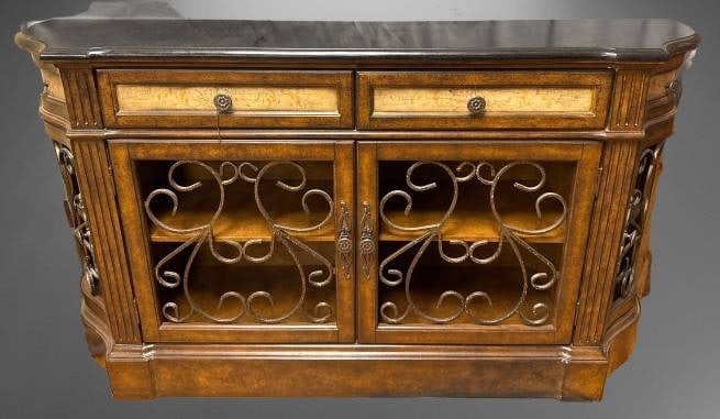 Modern Console Table With Decorative Doors: Measuring 62 inches wide, 35 inches tall, and 15 inches deep, this modern furniture piece features decorative metal door fronts and integrated shelving inside. Constructed by Home Meridian in 2012, it