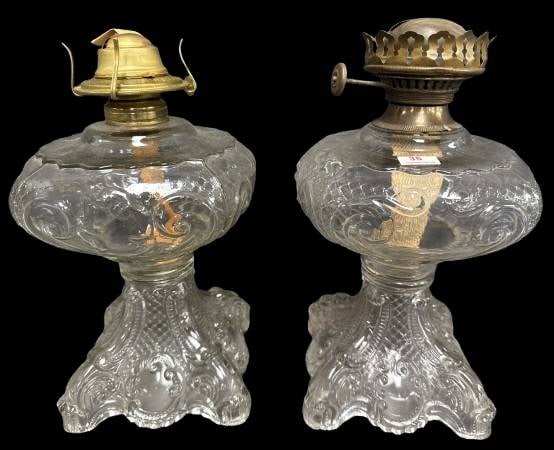EAPG Princess Feather Kerosene Lamps: (2) Early American Pattern Glass (EAPG) Princess Feather kerosene lamps. No chips, cracks, or repairs noted. Features molded glass bases and original burner components. A highly collectible duo reflec