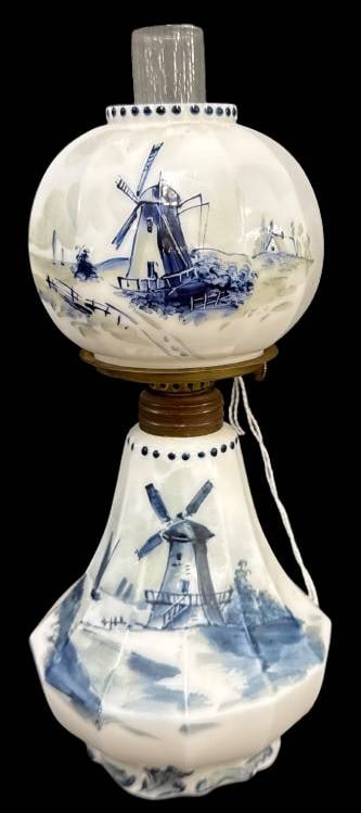Delft Miniature Oil Lamp by Pairpoint Glass Co.: This handpainted Delft miniature oil lamp by Pairpoint Glass Co. features detailed hand-painted Dutch scenes, imagery of windmills and sailboats on a white milk glass. Mrkd. Delft on base, P&A on burn