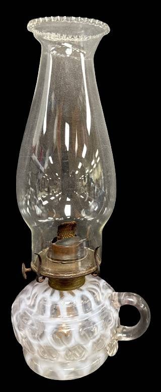 Opalescent Glass Finger Hold Oil Lamp: This Coin Spot opalescent finger hold oil lamp features a clear glass chimney. The piece showcases a functional design with a beautiful swirl pattern on the base. A great addition for collectors or pr