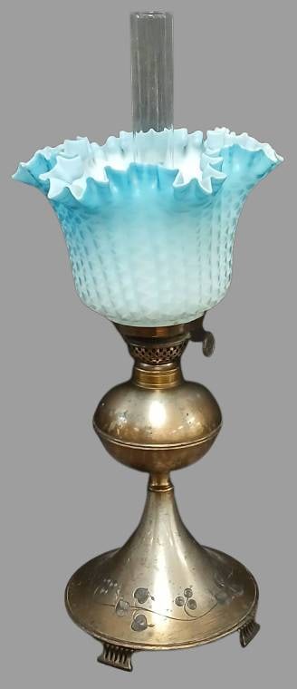 Marked Pairpoint Oil Lamp with Glass Shade: A marked Pairpoint Mfg. Co. oil lamp featuring a decorated base with floral etching and a blue opalescent ruffled glass shade. No chips, cracks, or repairs noted, however shows wear from use and handl