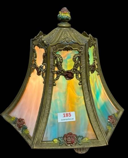 Multicolored Stained Glass Lamp Shade: This hexagonal lamp shade features multicolored stained glass panels framed by an ornate brass structure adorned with floral accents. Its intricate design highlights attention to detail, making it an