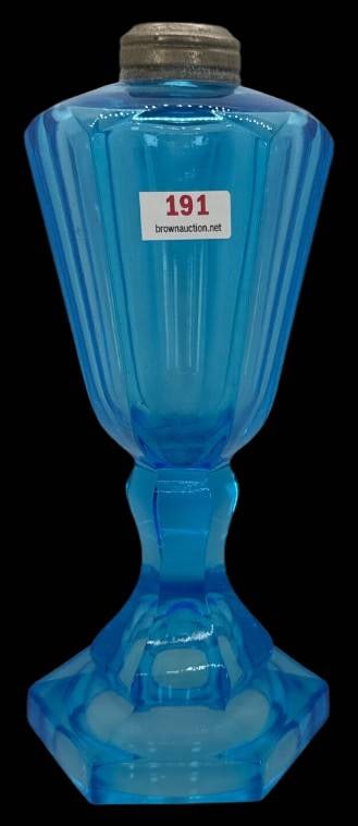Blue Glass Oil Lamp Base: This blue glass oil lamp base features an overall hexagonal form. Its bold color adds to its visual charm and historic appeal. Measures 8.5" tall. In-house shipping available.
