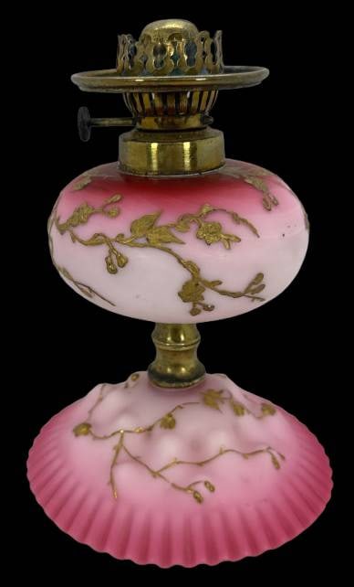 Pink Miniature Oil Lamp with Floral Detailing: This miniature lamp features a 2.5-inch diameter shade holder with no chips, cracks, or repairs. The pink and cranberry opaline satin glass is adorned with gold enameled floral detailing, paired with