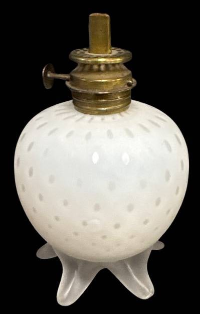 White Satin Mother-of-Pearl Miniature Oil Lamp: This unique miniature lamp features a white satin mother-of-pearl finish with a frosted glass ftd. base. Raindrop or air trap design. Measuring 5" tall, it has a small chip on one of its feet. Its cla