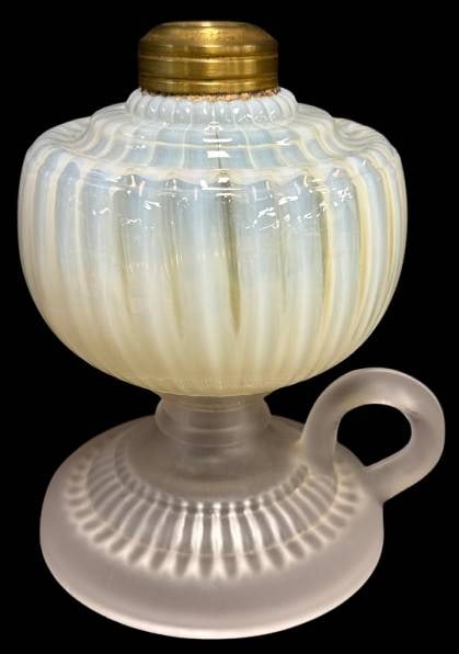 Pressed Glass Oil Finger Lamp with Brass Collar: This pressed glass oil finger lamp features a frosted base and a ribbed opalescent font, topped with a brass collar. Note: there are a couple of chips at the base edge. A charming piece for any collec
