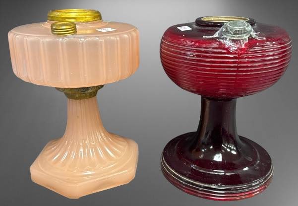 Aladdin Kerosene Mantel Lamps: This lot includes (2) Aladdin kerosene mantel lamps: Beehive/Wedding Bank, ruby betal crystal; Corinthian, rose moonstone. Ruby lamp has small nick but otherwise, free of chips, cracks, or repairs and