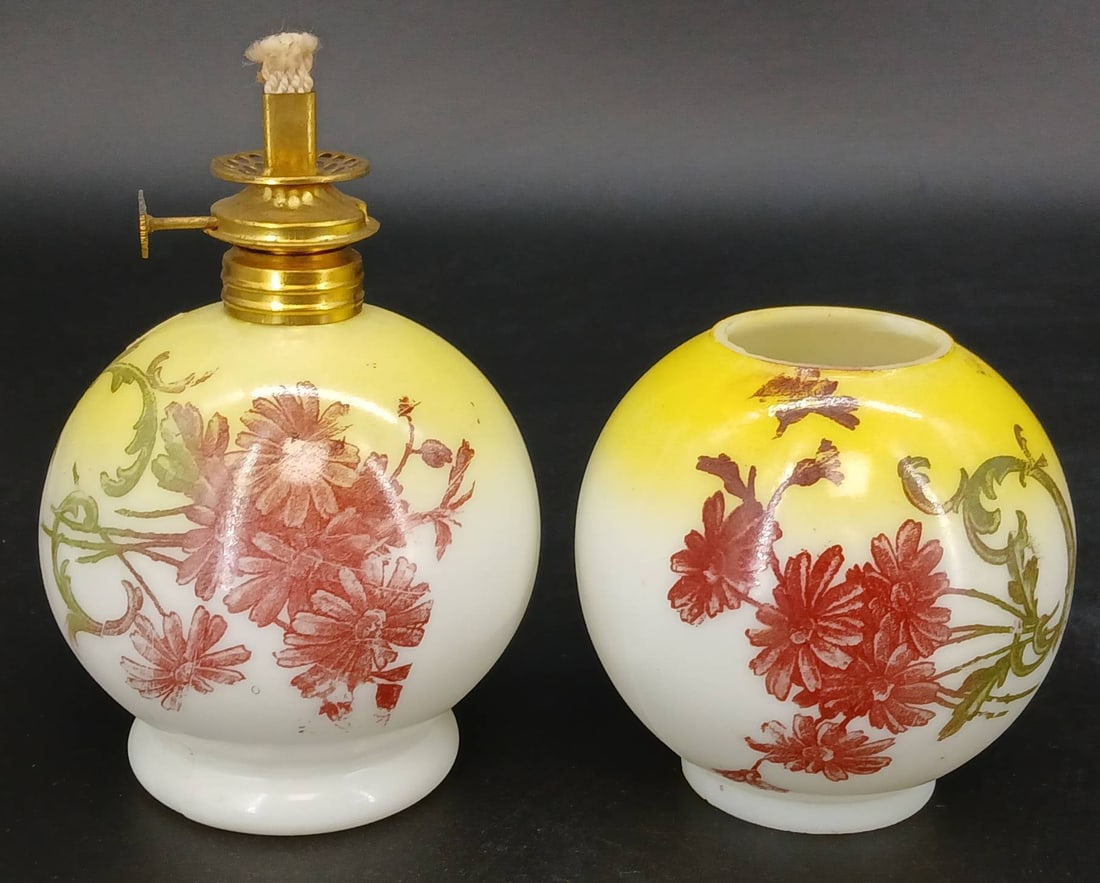 Miniature Glass Oil Lamp: Miniature cased glass oil lamp with floral design and brass burner. Hardware for the chimney and shade is missing, and chips are present on the rim. Measures 8-9" tall. In-house shipping available.