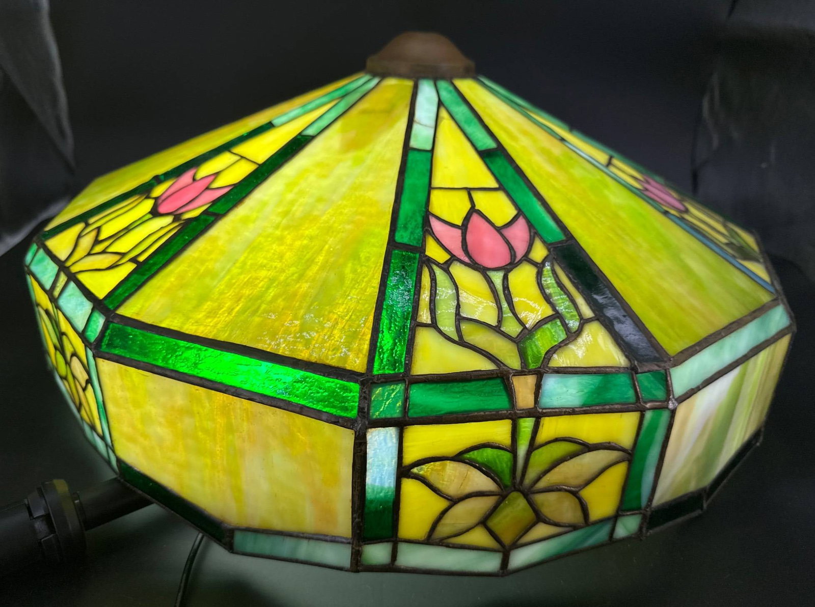 Stained Glass Lamp Shade, 20.5" Diameter: Stained glass lamp shade featuring a floral motif with pink and green hues, measuring 20.5" in diameter. Shows signs of wear including surface scratches and minor cracks in some panels. The top mounti