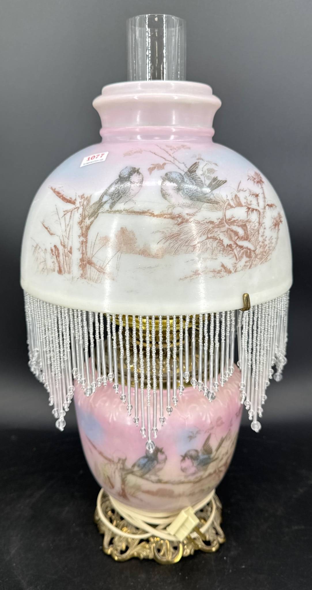 Wavecrest-Style Lamp with Bird Motif: Wavecrest-style table lamp measuring approximately 18" to the top of the shade. Features hand-painted bird designs on a pink and white glass body with fringe detail, brass accents, and an electric fit