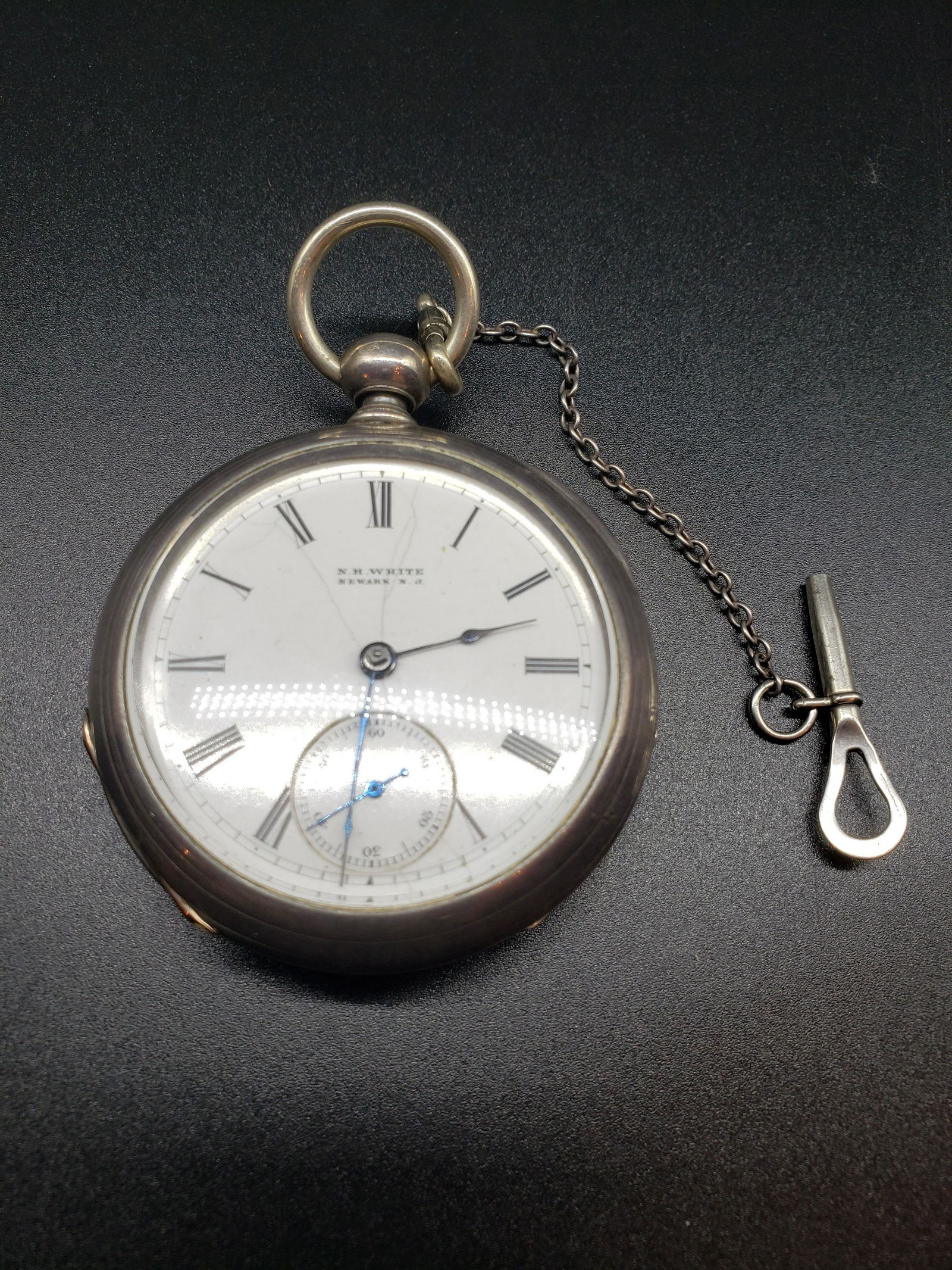 KEY WIND COIN SILVER POCKET WATCH: Key Wind Coin Silver N.H. White Newark N.J. Pocket Watch with Original Leather Case Piece is 2 1/4" x 2 1/4" All items from this Auction Located in in Hollywood Florida Warehouse For Shipping Call tod