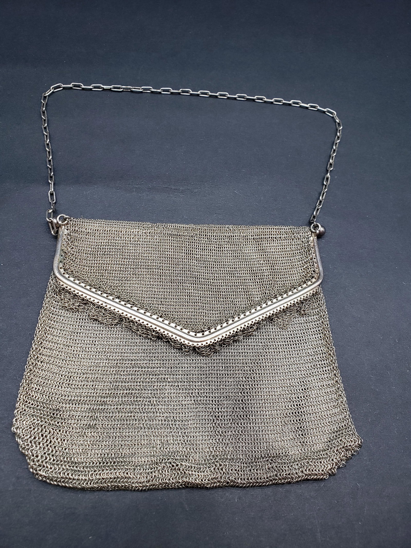 SILVER FOLD OVER MESH HANDBAG: Silver Fold Over Mesh Handbag Piece is 5" x 5" with Chain 12" Long All items Located in in Hollywood Florida Warehouse For Shipping Call today for quote they have item numbers and Pak Mail is availabl