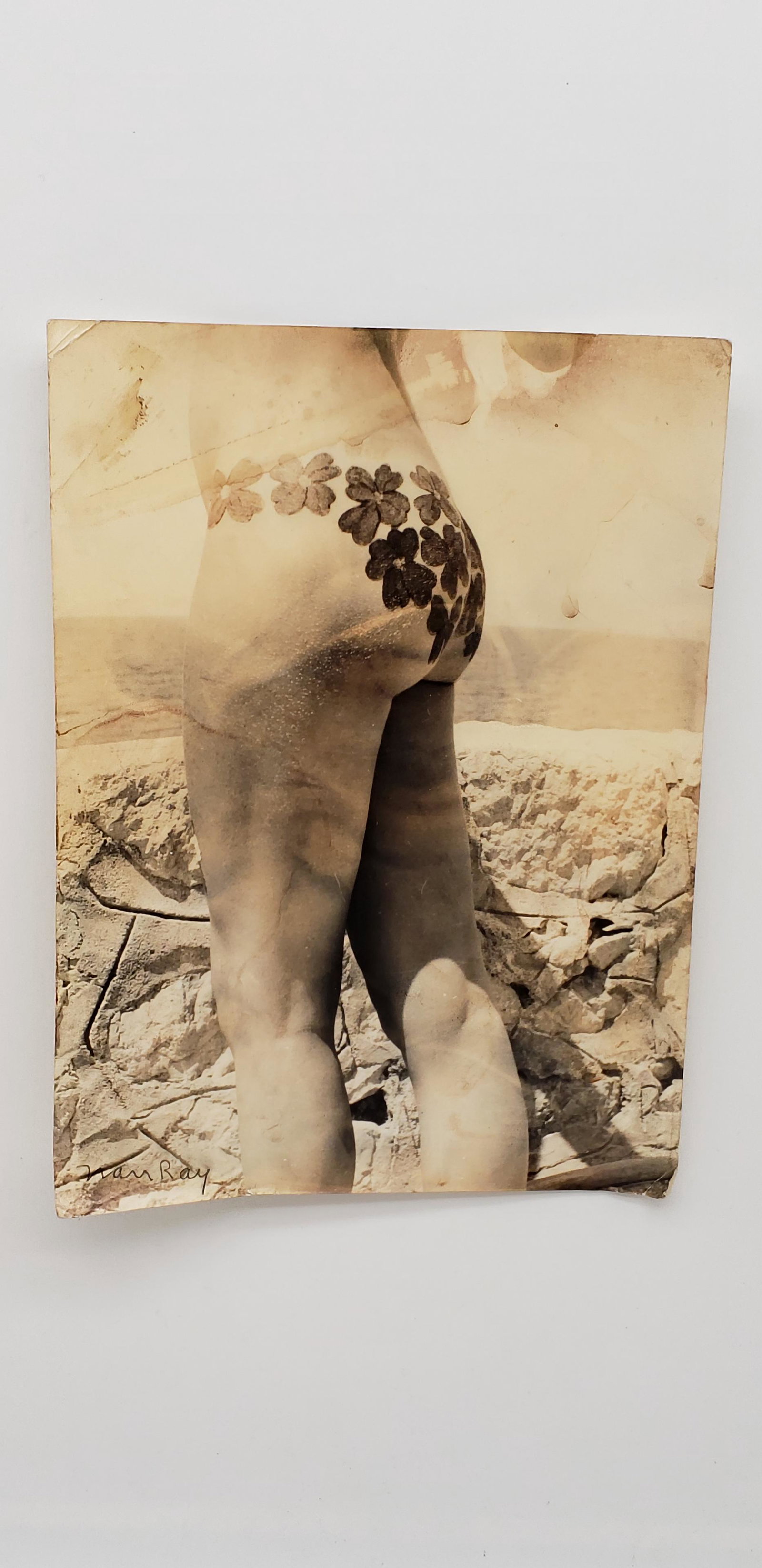 MAN RAY PHOTOGRAPH: MAN RAY PHOTOGRAPH. SIGNED. SOME WEAR AND WATERMARKS DUE TO AGE. AS IS. 9 1/2" X 7"Man Ray (born Emmanuel Radnitzky; August 27, 1890 â€“ November 18, 1976) was an American visual artist who spent