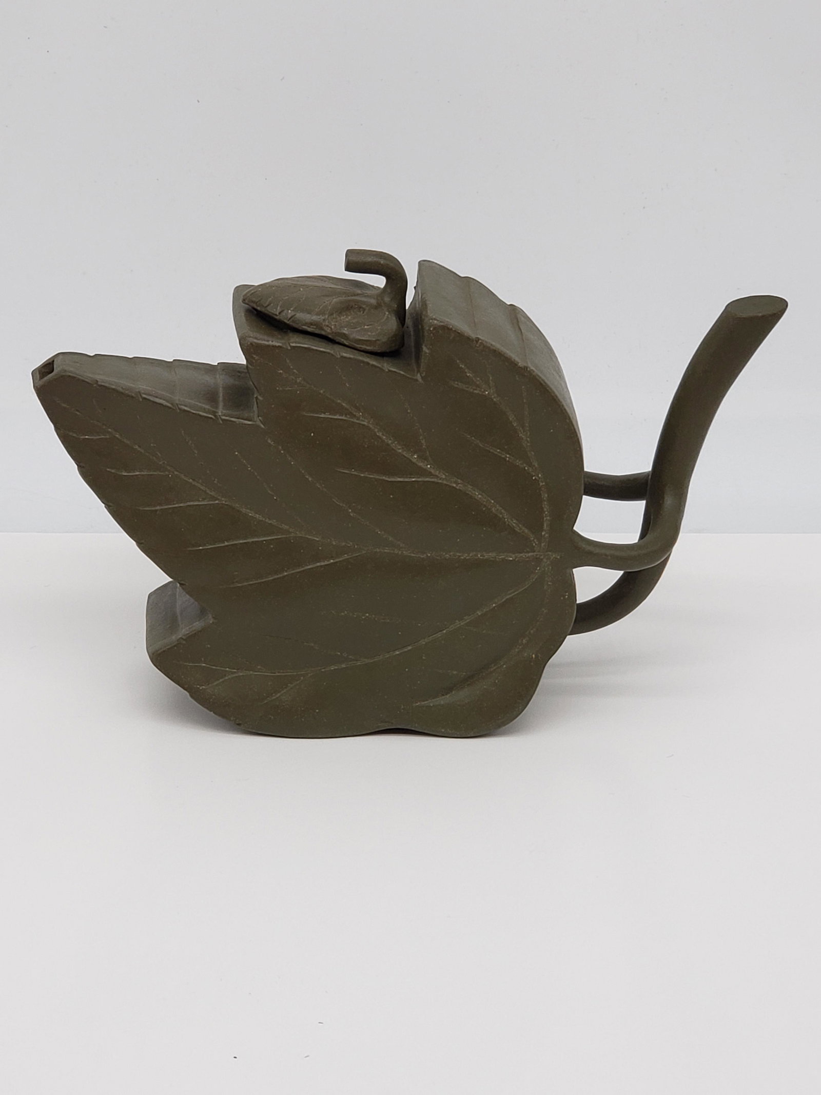 CHINESE GREEN LEAF CLAY TEAPOT: CHINESE GREEN LEAF CLAY TEAPOT. WITH BOX. 6 1/4" X 4 1/4" X 1 3/4" All items Located in Hollywood Florida Warehouse. Thank you for your inquiry about shipping your precious item/items purchased at Puc