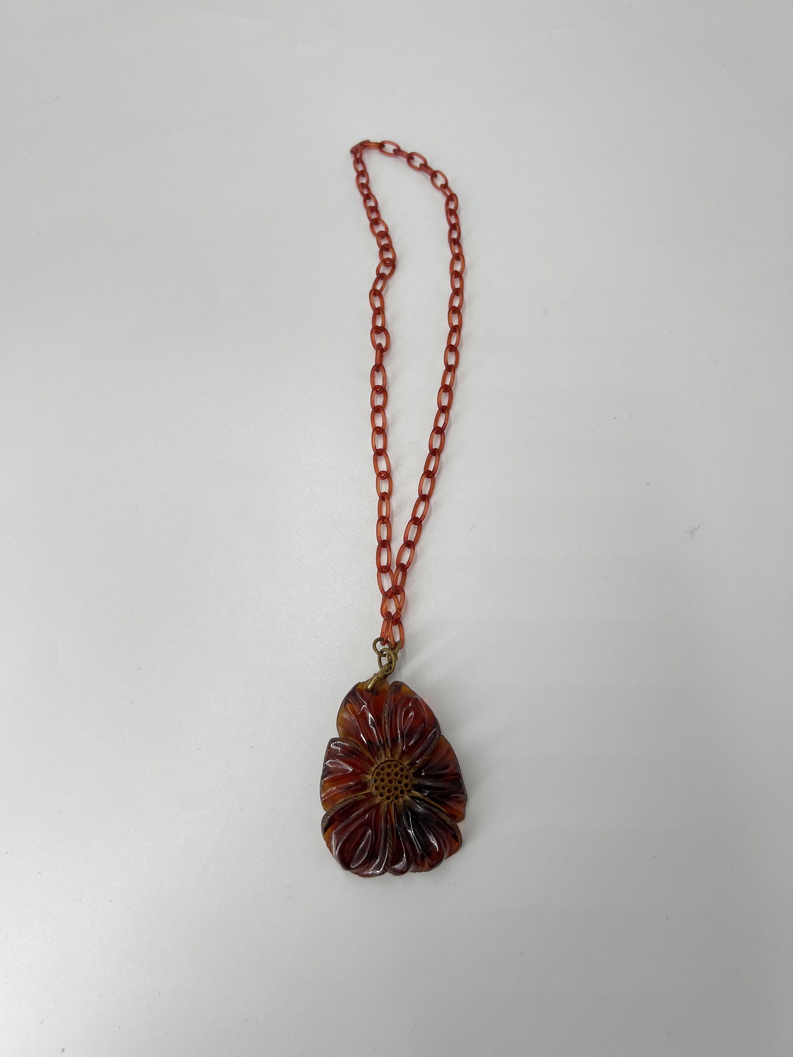 BAKELITE FLORAL NECKLACE: BAKELITE FLORAL NECKLACE 20 1/2" PENDANT 2 1/2" X 2" All items Located in Hollywood Florida Warehouse. Thank you for your inquiry about shipping your precious item/items purchased at Puckett Auctions.