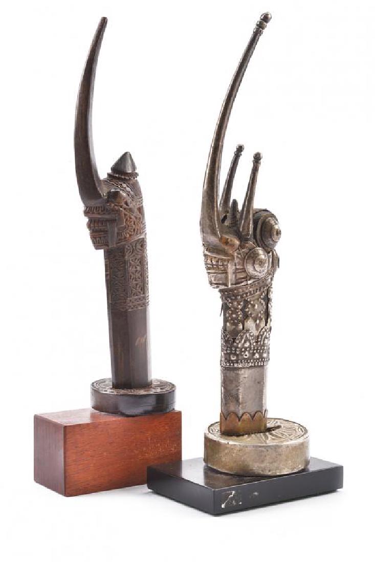 A lot of two rare sword hilts, dating: circa 1900,: A lot of two rare sword hilts, dating: circa 1900, provenance: The Philippines, dating: circa 1900, provenance: The Philippines, One is horn, finely carved with a stylized face and long nose; the othe