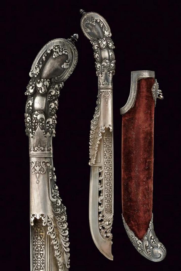 A fine silver Phia-Kaetta with scabbard by Ferdinand: dating: about 1870 provenance: Paris, Completely silver, finely engraved and partially pierced with floral motifs, back signed 'F. BARBEDIENNE'. Wooden scabbard covered with brown velvet (partially wo