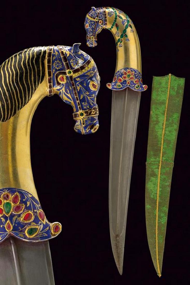 A fine enameled dagger: dating: Second half of the 20th Century provenance: India, Wide, slightly curved, double-edged blade with central raiser and reinforced tip, ribbed in the centerline; gilded brass hilt with pommel sha