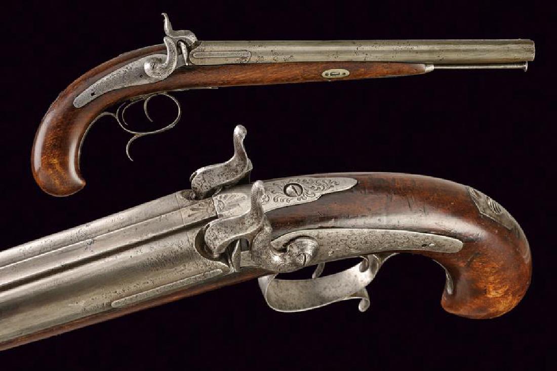 A double barrelled percussion pistol: dating: Mid 19th Century provenance: Europe, Very long, smooth-bore, round, 17 mm cal. barrels, with rib and fore-sight, base with engraving; tang engraved and with sight, backward spring locks engrav