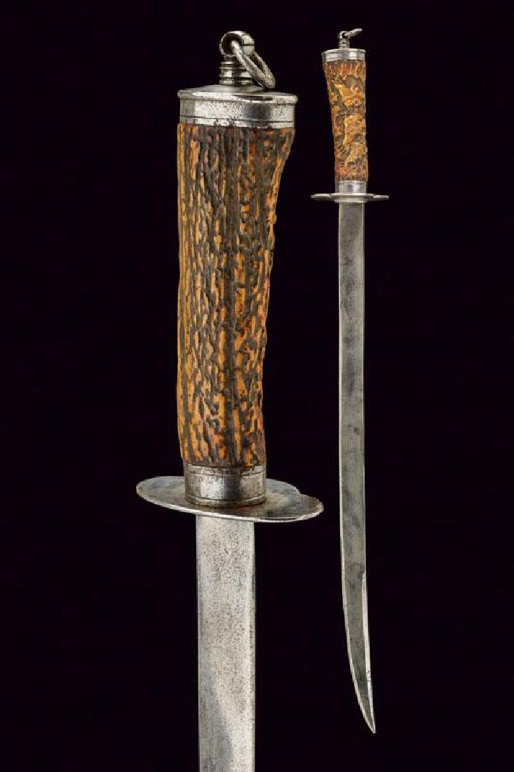 A hunting hanger: dating: circa 1800 provenance: Germany, Curved, flat, single-and false-edged blade. Deer horn grip finely embossed in the front part with battle cavalry. Steel mounts. Cap with suspension ring. length