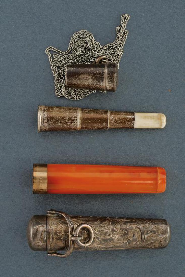 A lot of two cigarette holders: dating: First half of the 20th Century provenance: England, One in amber with gilded, silver ring and stamped. In a silver case engraved with floral motifs and with stamps on the cover; the other in a