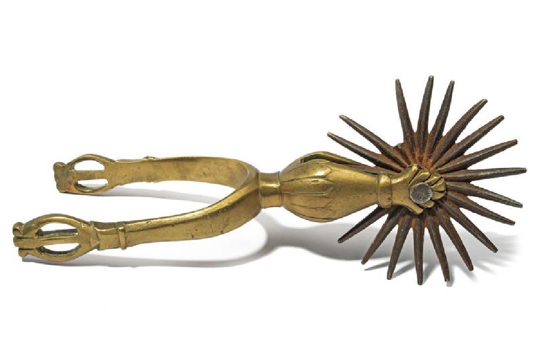 A spur: dating: 19th Century provenance: Peru, In brass, of big dimension, iron, star-rowel. length 24 cm.