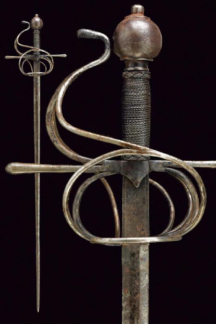 A composite rapier: dating: circa 1600 provenance: Germany, Straight blade of hexagonal section, ribbed at the foible, with outlined ricasso, of the same size. Iron hilt with upper and lower ring-guard, the upper one wit