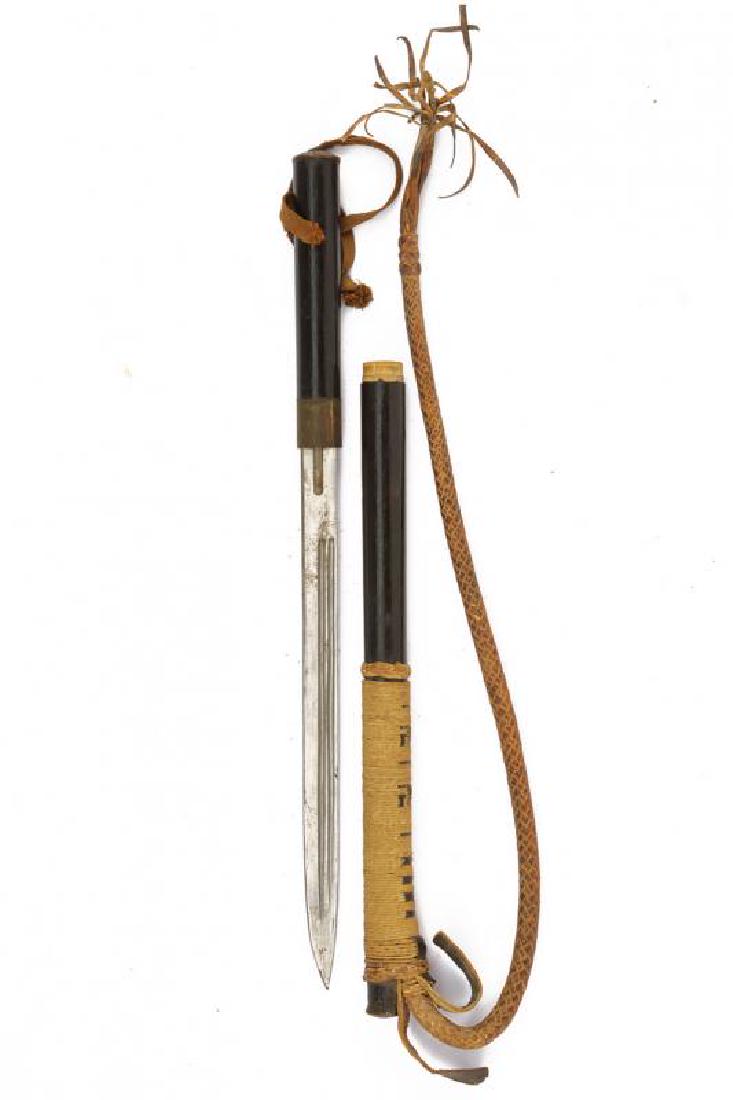 A dagger with whip: A dagger with whip dating: first quarter of the 20th Century provenance: East Asia, Single-edged blade with double groove, metallic ring-nut, cylindrical, wooden, lacquered grip, cap in material of Ja
