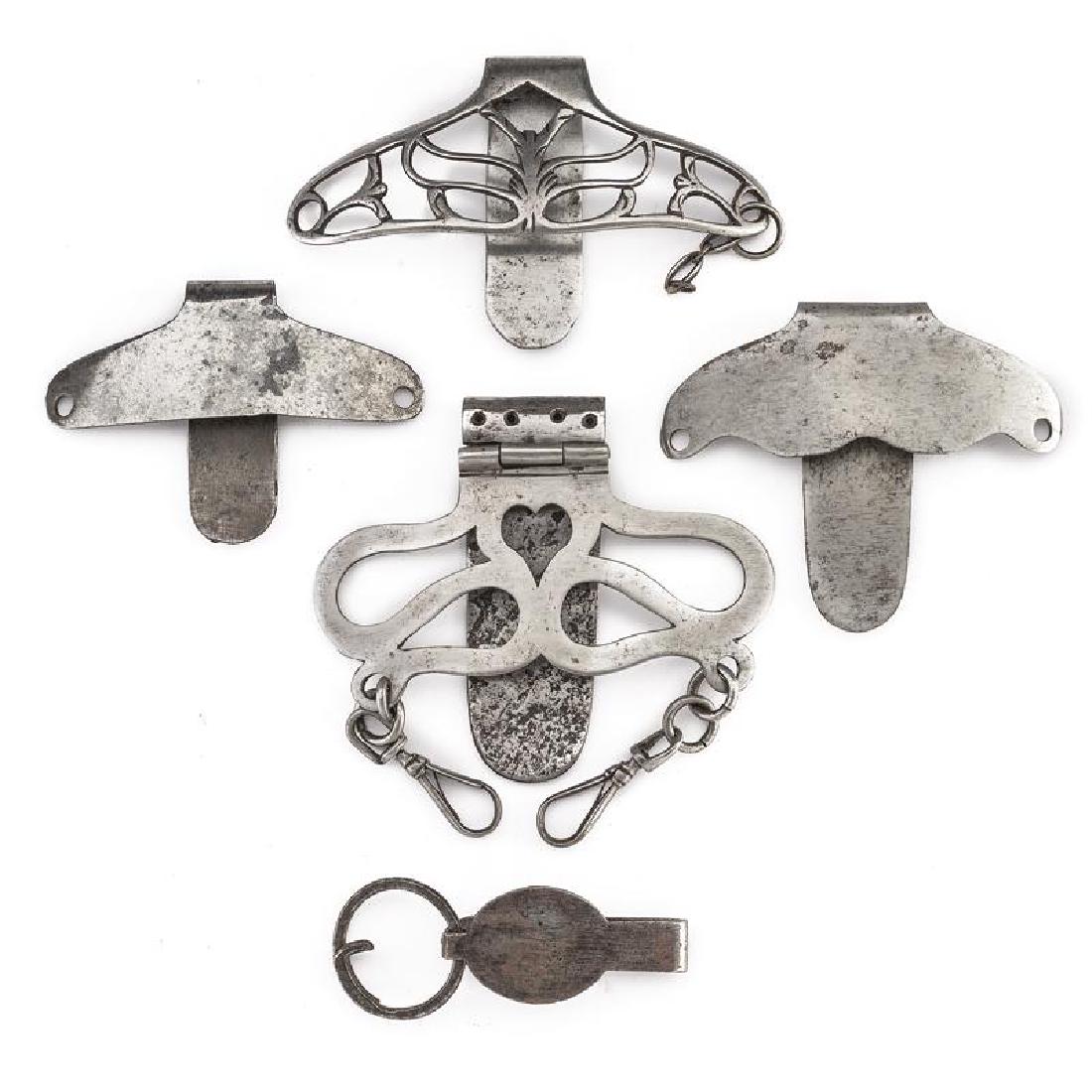 A lot of bandolier buckles for swords and rapiers: dating: 18th Century provenance: France, In iron, one richly pierced with floral motifs, one pierced with heart and three smooth. width 2.5 - 11 cm.