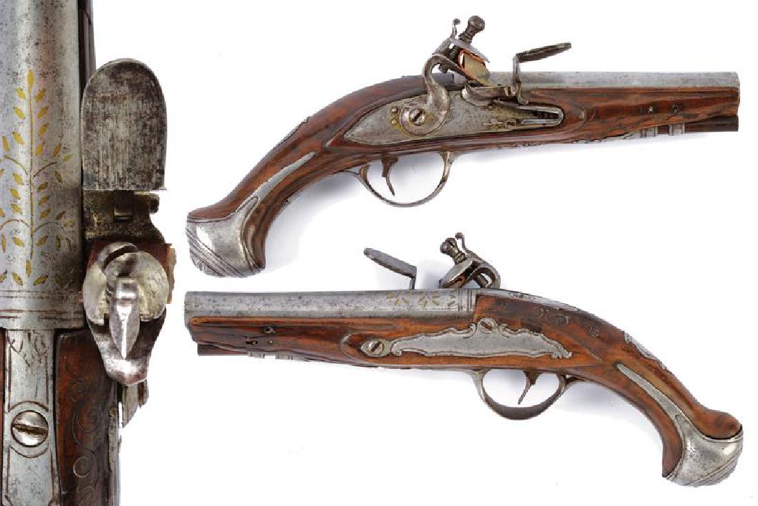 A pair of traveling flintlock pistols by Bianchi: dating: last quarter of the 18th Century provenance: North Italy, Round, smooth-bore, 13 mm cal. barrels, decorated with brass-inlaid floral motifs; locks signed 'G. BIANCHI', wooden, full stocks with