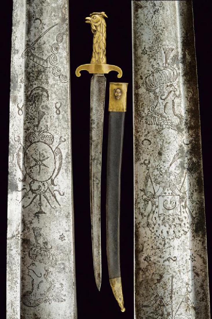 A sapper's dagger: dating: Early 19th Century provenance: France, Wide, slightly curved, single-and false-edged blade, with large, central fuller, the base engraved with trophies and Turkish head; solid brass hilt, with