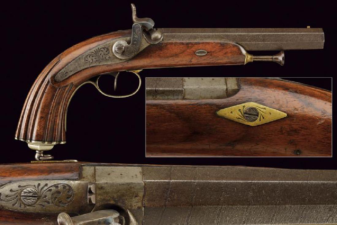 A percussion pistol: dating: Mid 19th Century provenance: Italy, Rifled, octagonal, 17 mm cal. barrel, in damask, with smooth base and fore-sight; engraved tang, with rear sight; backward spring lock, engraved with floral