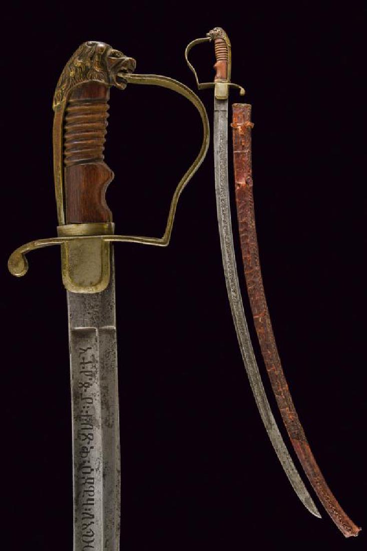 An officer's sabre: dating: circa 1900 provenance: Ethiopia, Curved, single-and false-edged blade with large, central fuller and thin groove on the back, engraved with rinceaux on the left side and long inscription in Am