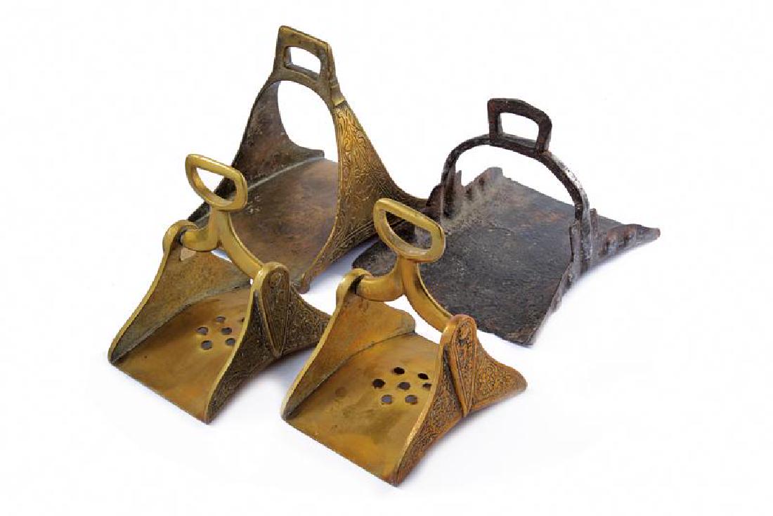 A lot of stirrups: dating: 18th/19th Century provenance: Arabian Peninsula, A pair in bronze, with floral decorations, one single, in bronze, decorated with floral engravings and one rare, in iron, with wide tread. heig