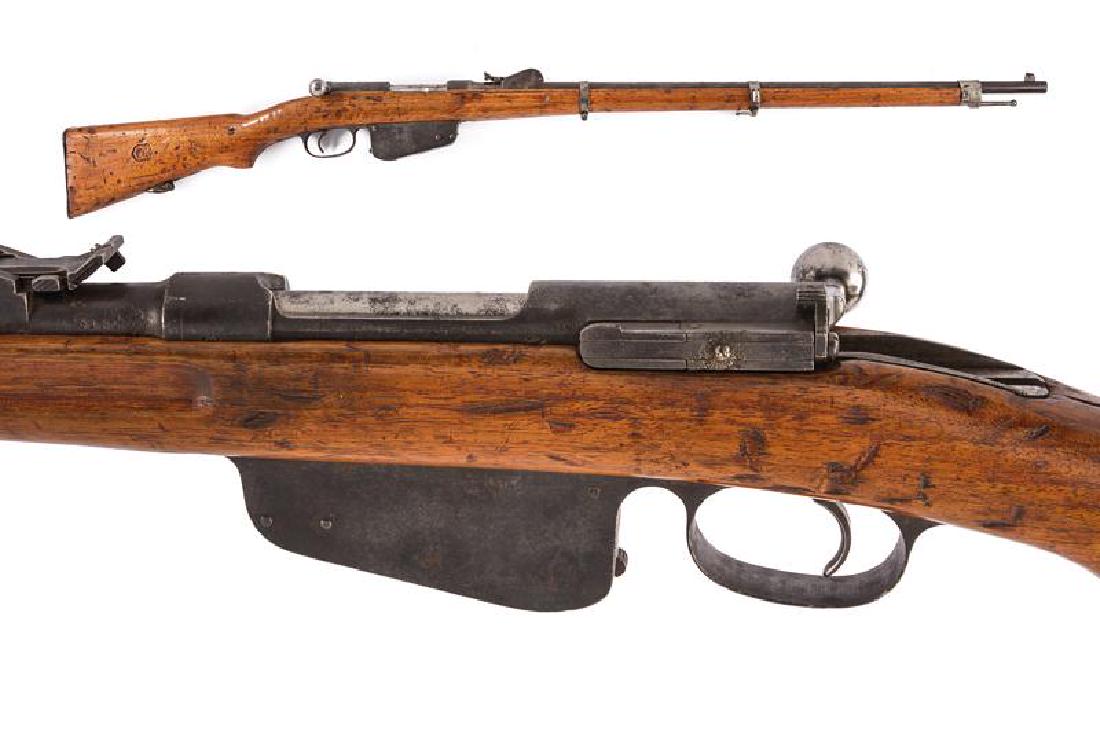 An 1886 model Steyr-Mannlicher rifle: dating: about 1888 provenance: Austria, Round, rifled, 11 mm cal. barrel, marked at the base '3184' and 'CEWG', adjustable rear sight, fore-sight and clutch for a bayonet; wooden, full stock (signs of
