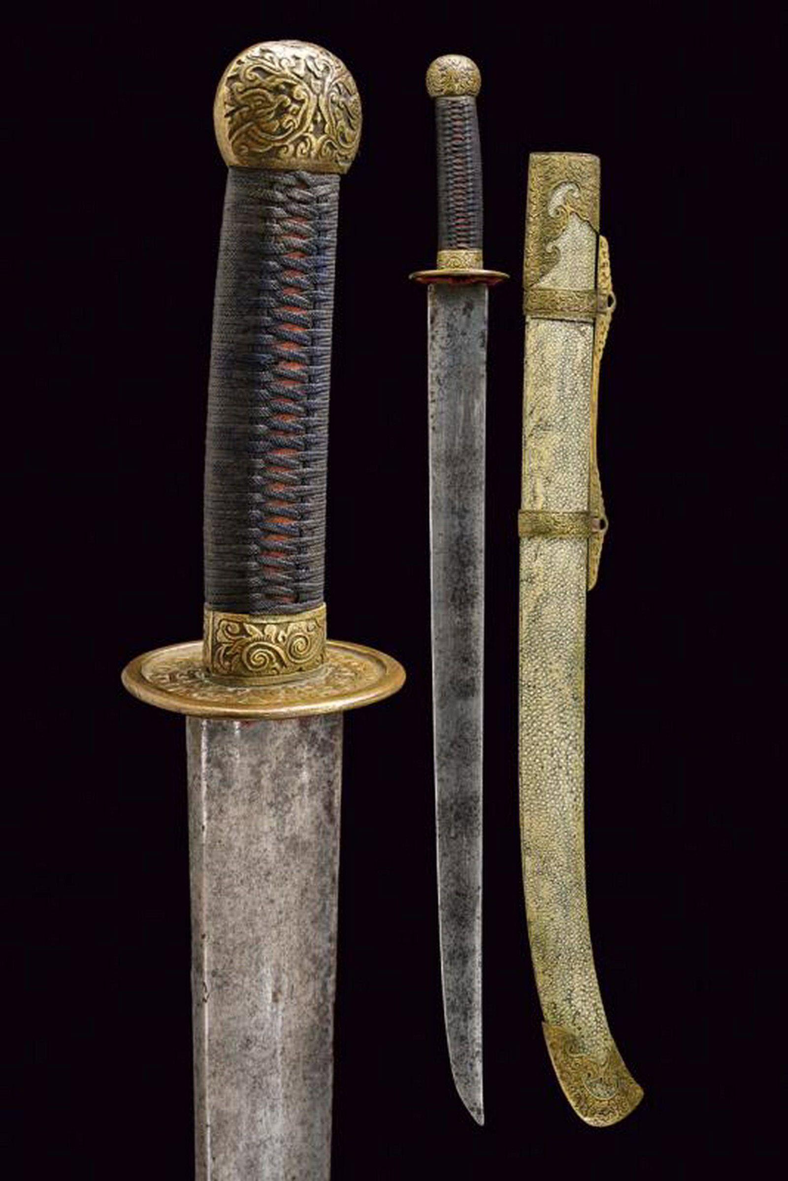 A dao (sabre): dating: 19th Century provenance: China, Strong, straight, single-edged blade, of straight shape, slightly curved at the tip. Brass hilt, finely engraved and carved in relief with rinceaux. Wooden grip