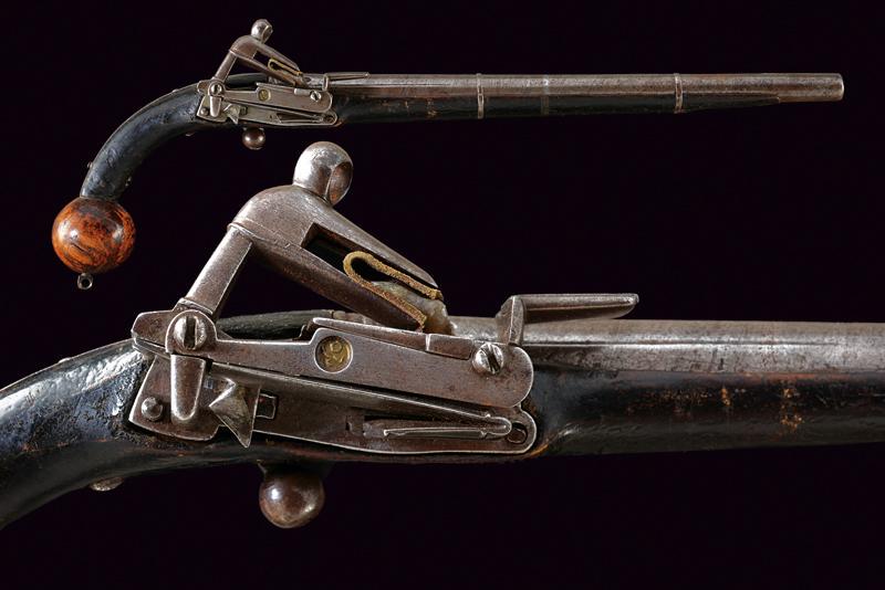 A cossack's flintlock pistol: dating: Mid 19th Century provenance: Caucasia, Round, smooth-bore, iron, 11 mm cal. barrel, probably damask, with Arabic stamps and inscriptions at the base, rib; miquelet, iron lock with Arabic stamp