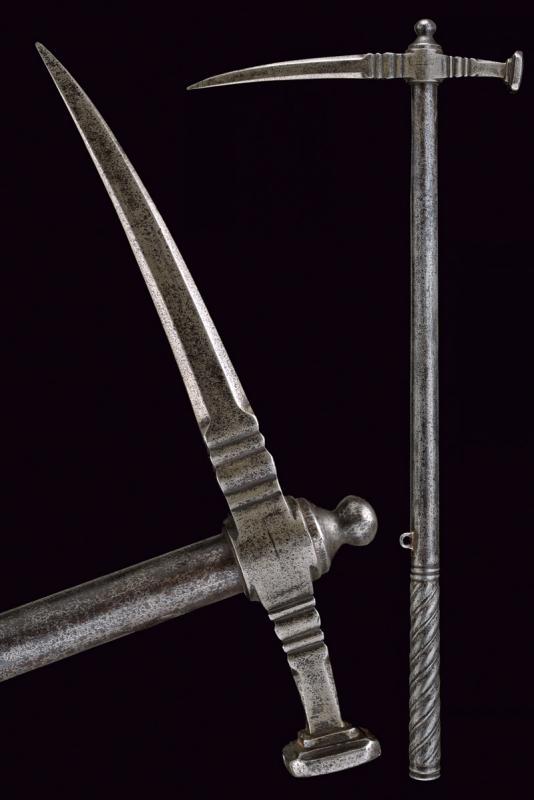 A war-hammer: dating: 16th Century provenance: Germany, Completely in iron, slightly curved spike with base with hollow chisels, of octagonal section, base chiselled en suite with the spike's one, enlarged and squa