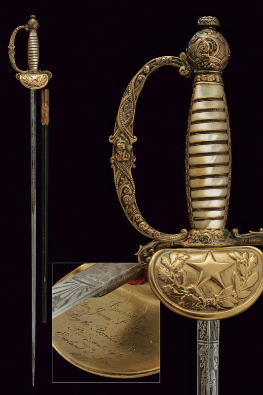 An honor sabre with inscription to James P. Henderson: dating: 19th Century provenance: Texas, Blade of triangular section, engraved with trophies and floral motifs on a gray ground. Brass hilt, shell-guard with a star inside the laurel branches, back par