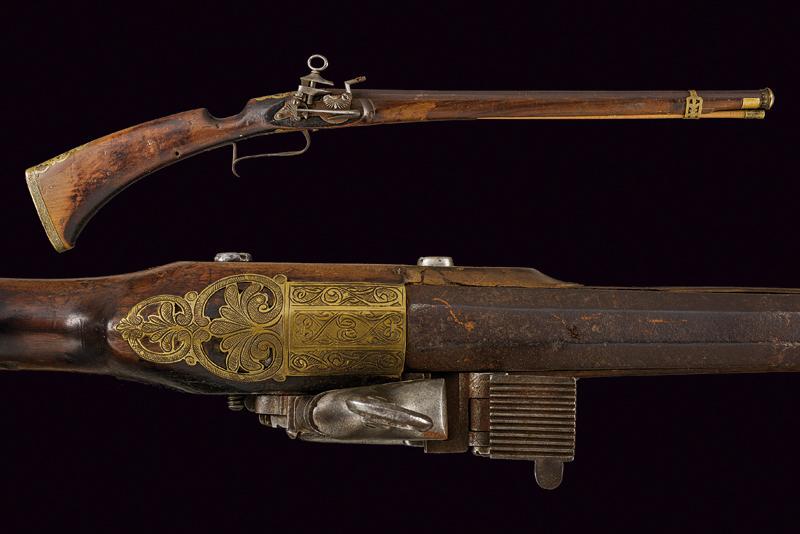 A rare and early miquelet flintlock carbine: dating: late 17th Century provenance: Spain, Smooth-bore, two-stage, 19 mm cal. barrel, first octagonal then of sixteen facets, with brass, gilded, engraved moulded muzzle; miquelet lock, chiselled wi