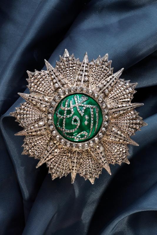 Order of Glory (Nichan Iftikhar): dating: last quarter of the 19th Century provenance: Tunisia, Plate of Grand Cross in layered silver, chiselled, pierced and carved with faceting, central part in green enamels, with silver monogram o