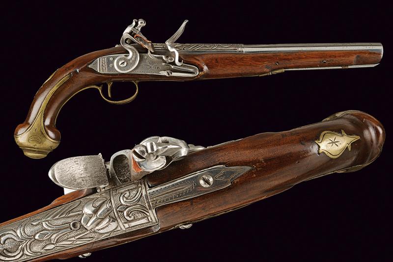 A flintlock pistol: dating: Second quarter of the 19th Century provenance: Turkey, Smooth-bore, two-stage, 15 mm cal. barrel, first part richly chiselled with trophies and floral motifs on a grained ground, round after a