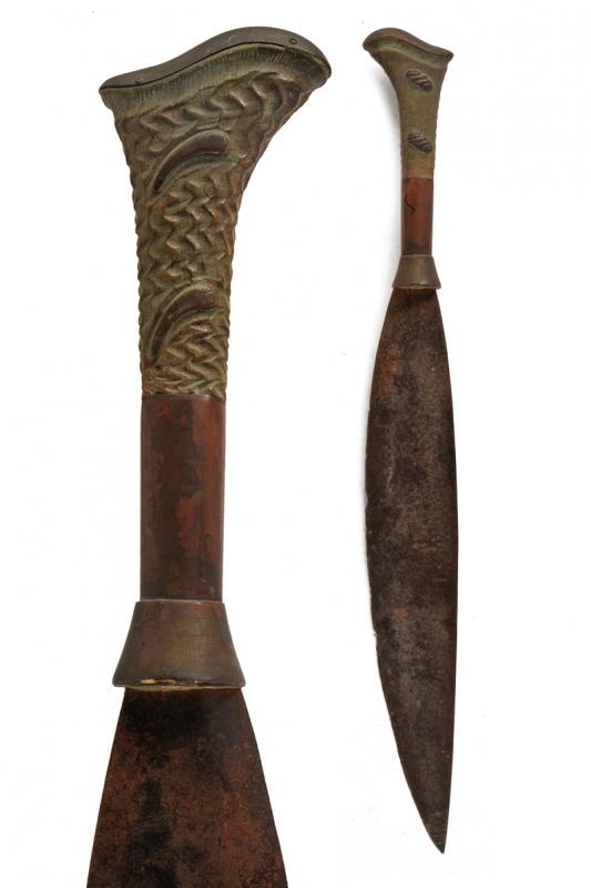 Barong: dating: 19th Century provenance: Mindanao, Wide and strong, single-edged blade with pitting from tribe wars. Grip completely covered with brass foil, partially solid. Very scarce. length 59 cm.