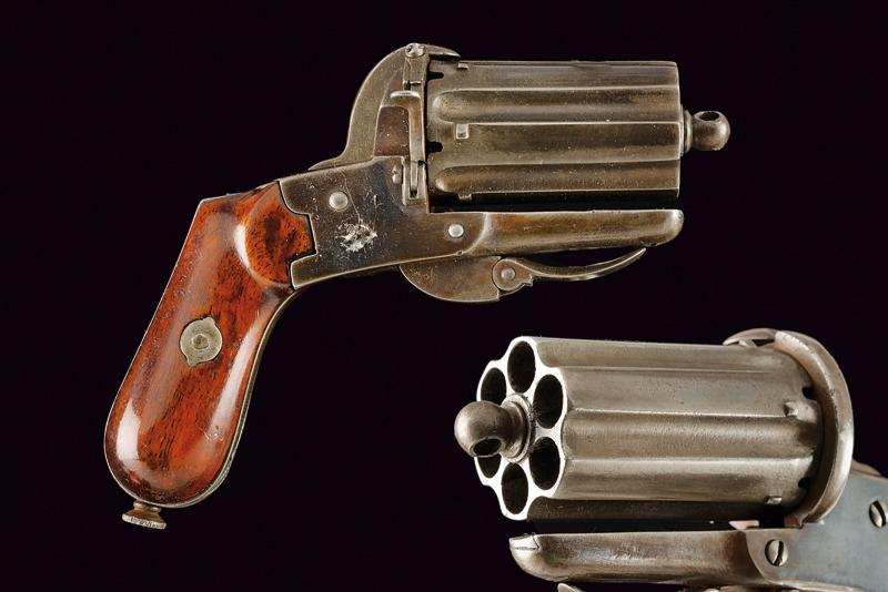 A pin-fire pepperbox revolver: dating: about 1870 provenance: Belgium, Six-shot, grooved, 7 mm cal barrel/cylinder group; smooth frame. Mark of the Liege test bench. Loading gate, folding trigger. Fine wooden grips, butt-plate with