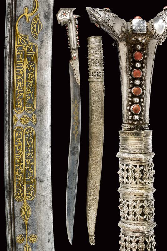 An elegant silver-mounted yatagan: dating: 1818 provenance: Turkey, Curved, single-edged blade with double fuller near the back; with two cartouches on the left side featuring Arabic characters consisting of gilded inlays and six-tippe