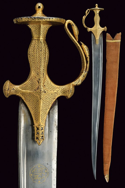 A rare and important sosun pattah: dating: circa 1800 provenance: India Wide, slightly curved blade similar to the ones of khyber knives, with single-edged, damask blade (very clean), with rear groove and "T"-back, on one side of the b