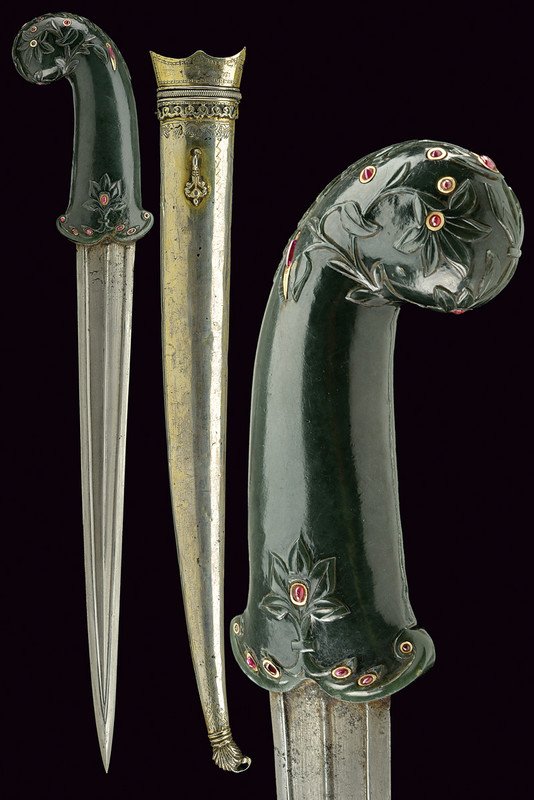 A very fine kandshar with jade hilt and red stones: dating: circa 1800 provenance: Turkey Strong, straight, damask blade, slightly thickened at the tip, with two wide, outlined grooves converging at the foible, at the centre a thin raiser (some pitting