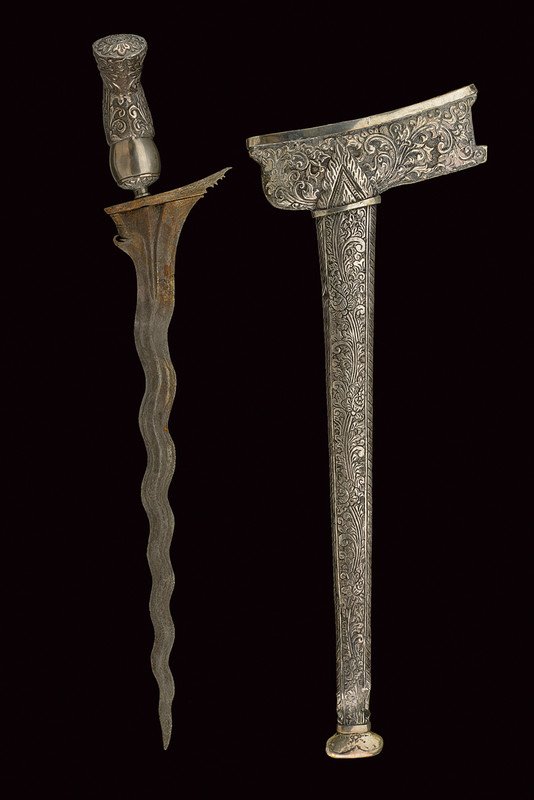 A kris: dating: circa 1900 provenance: Giava Straight blade with double, undulated edge and chiselled base; silver-plated grip decorated with embossed floral motifs; silver-plated wrangka and gandar decorated