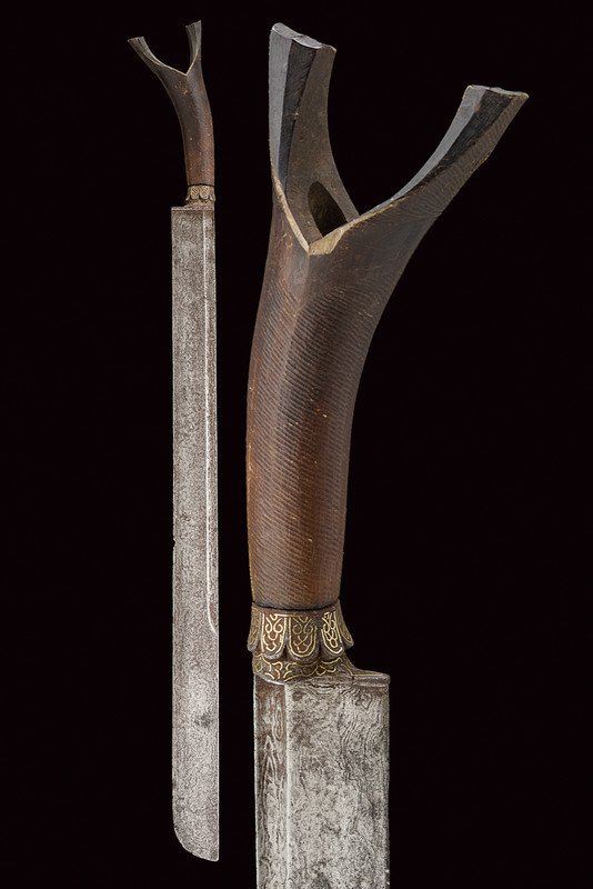 A Sikin Panjang: dating: third quarter of the 19th Century provenance: Sumatra Straight, single-edged, damask (pitting on the surface) blade, the tip rounded at one side, a fuller on three-quarters of the length at th