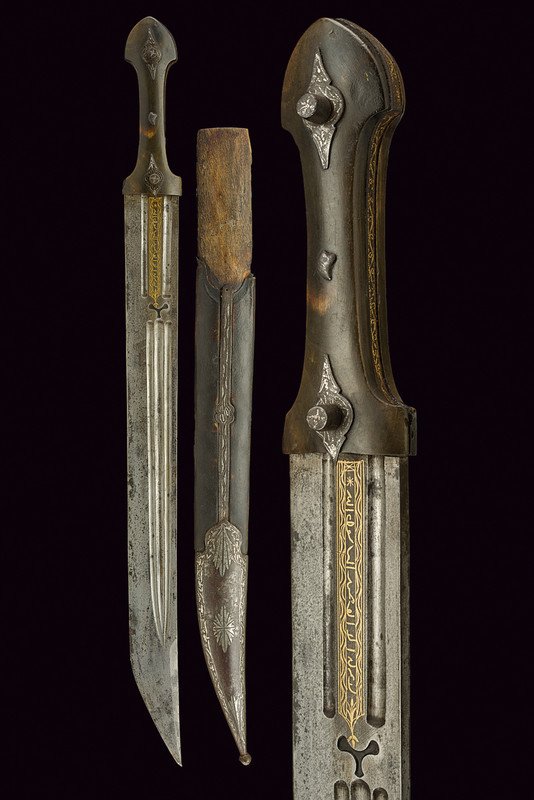 A qaddara: dating: 19th Century provenance: Caucasia Strong, almost straight, single -and short false-edged blade, with triple fuller on both faces, on one side -at the forte- two segments with fuller and a gold